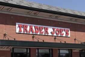 Facade of a Trader Joes store with the store name in bold letters on a brick building