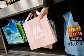 A display of Aldi-branded and reusable shopping bags