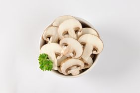 Bowl of sliced fresh mushrooms. 