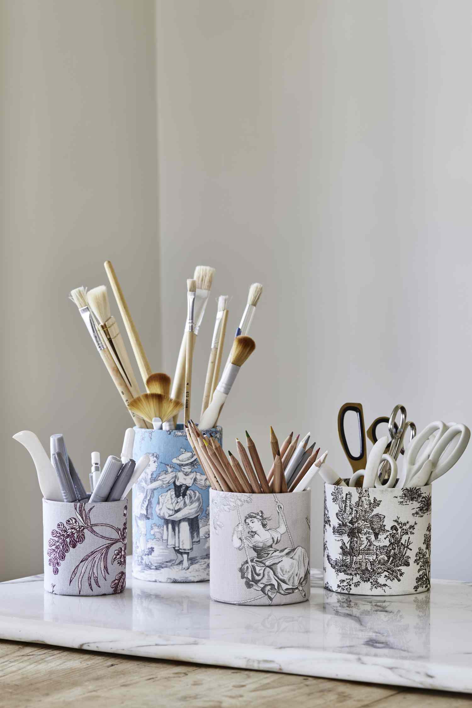 Toile mugs with paint brushes