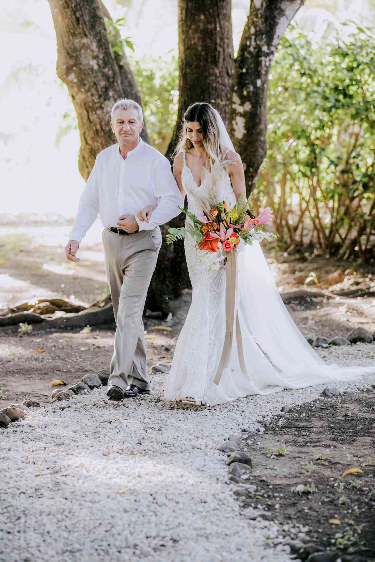 father of the bride walking bride down outdoor costa rican wedding venue aisle