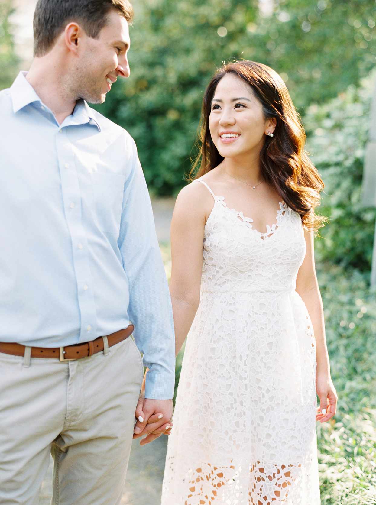 bride in white lace brunch attire and groom in light blue shirt