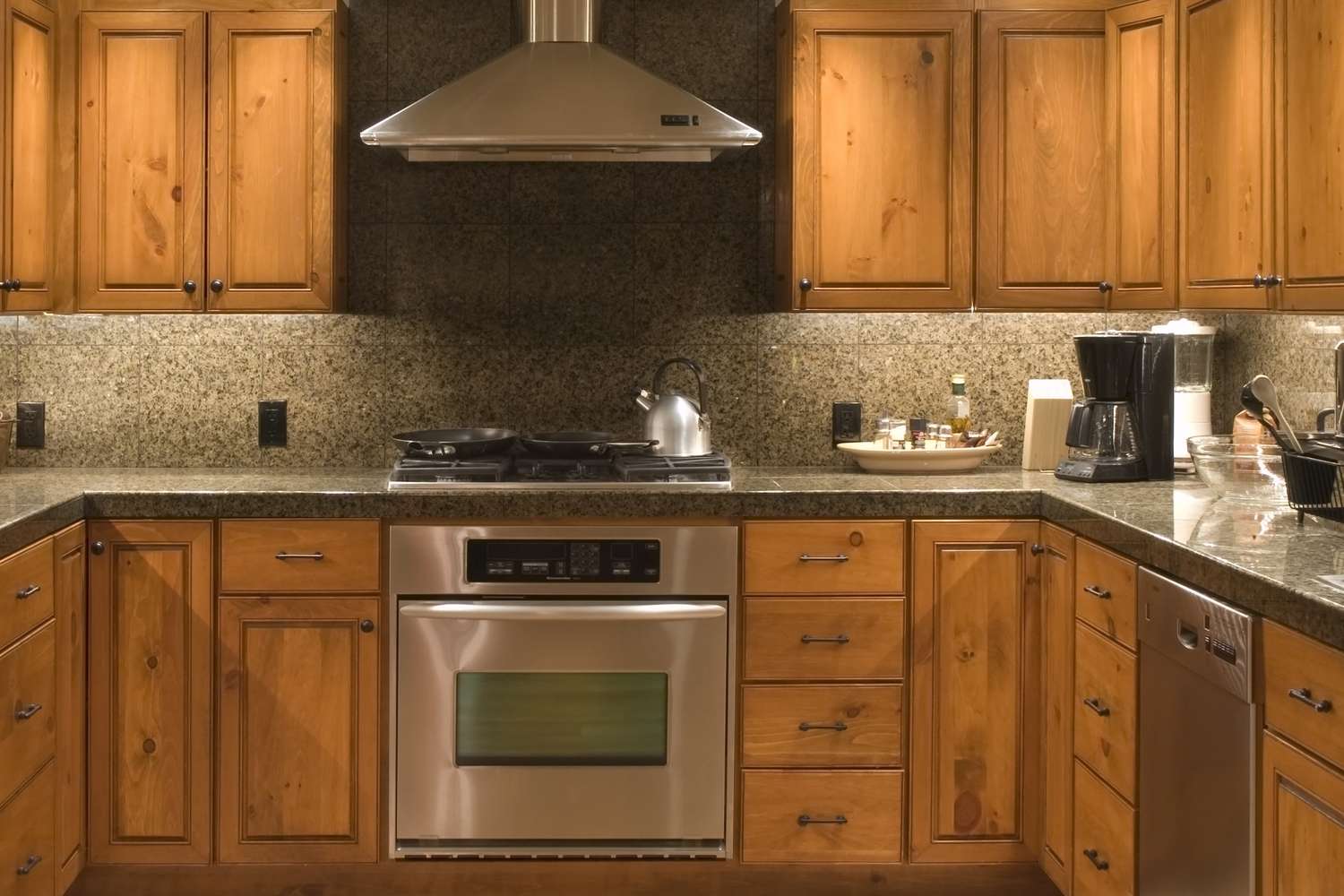 kitchen with well lit wood cabinets