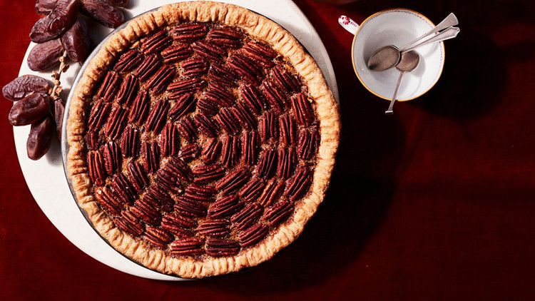 date-nut pie on red table cloth with tea