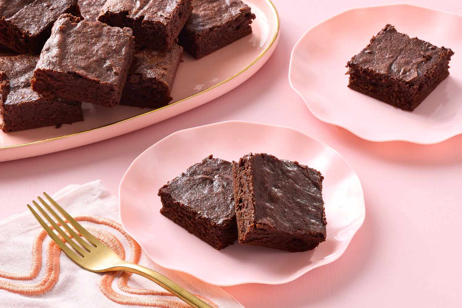Tray of brownies and servings on plates