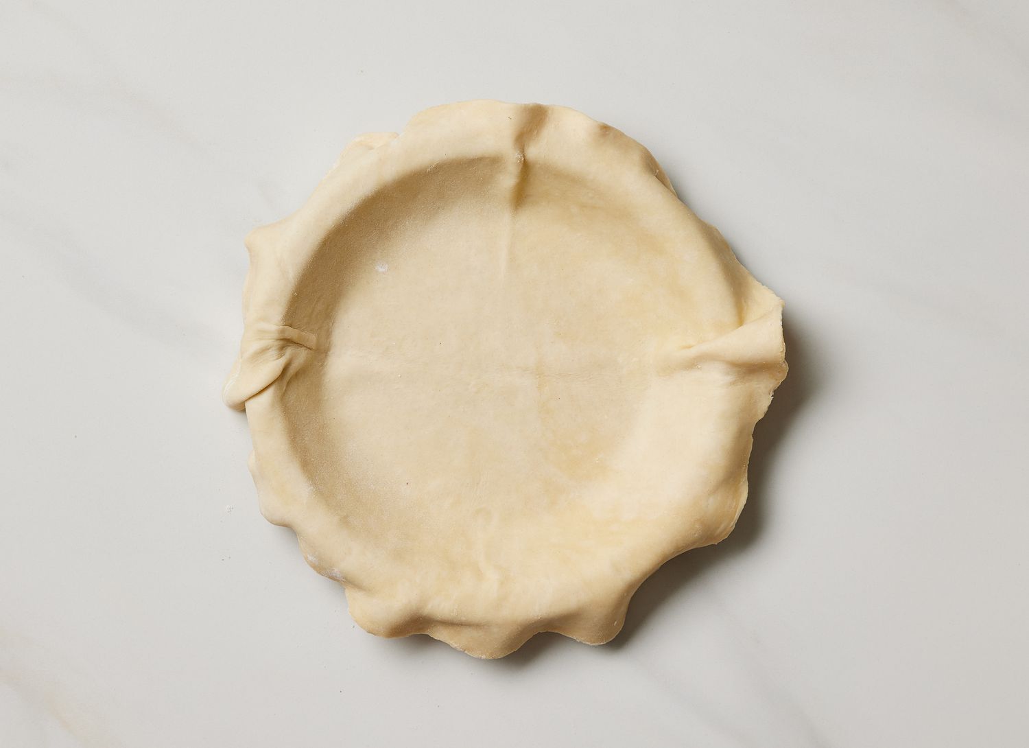 overhead view of pie crust in a pie pan