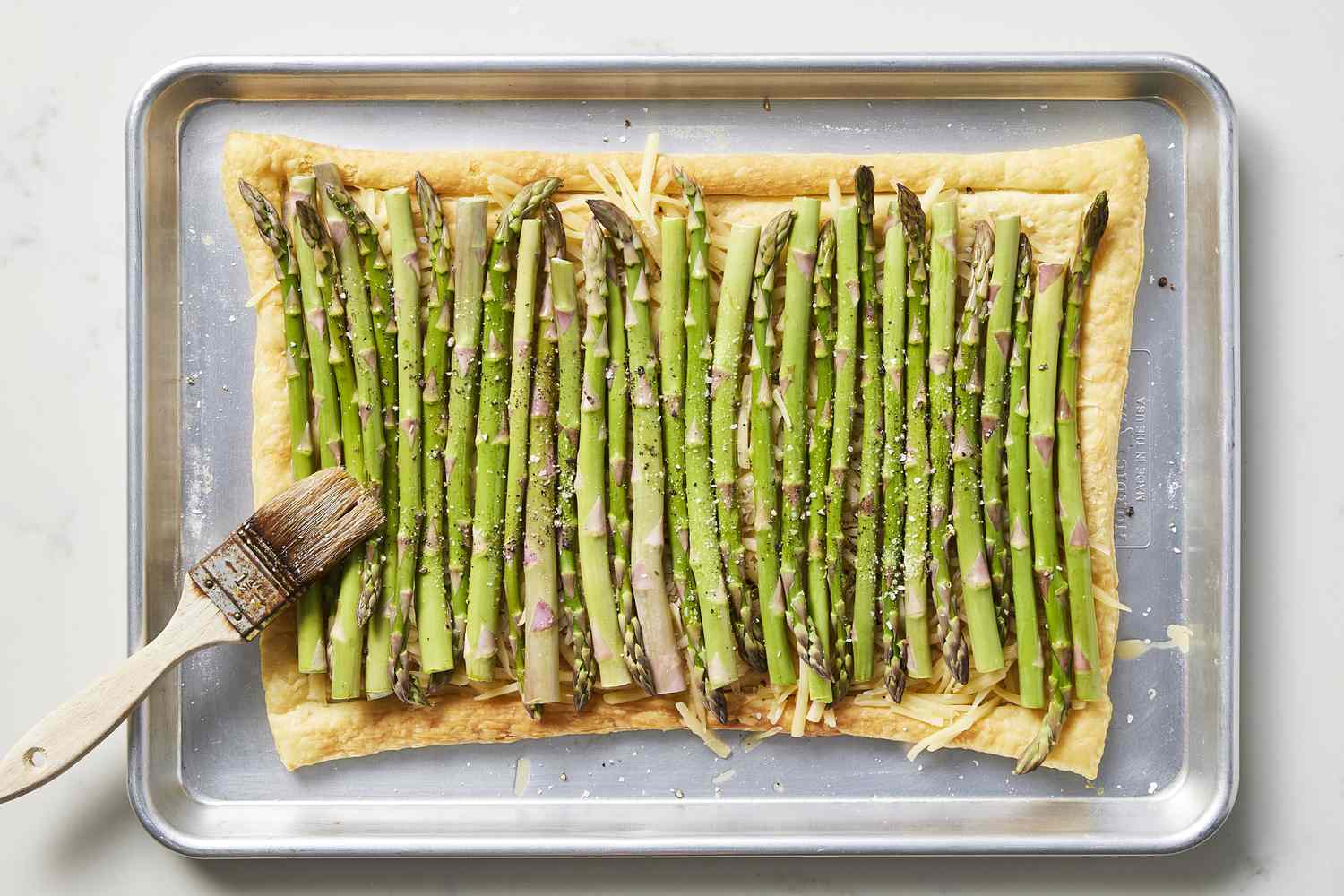 Asparagus on baking sheet drizzled with oil