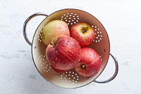 Freshly washed apples in a colander