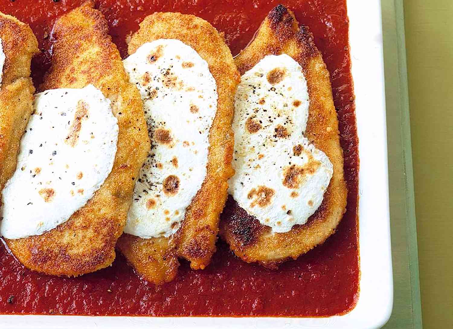 chicken parmesan in white serving dish