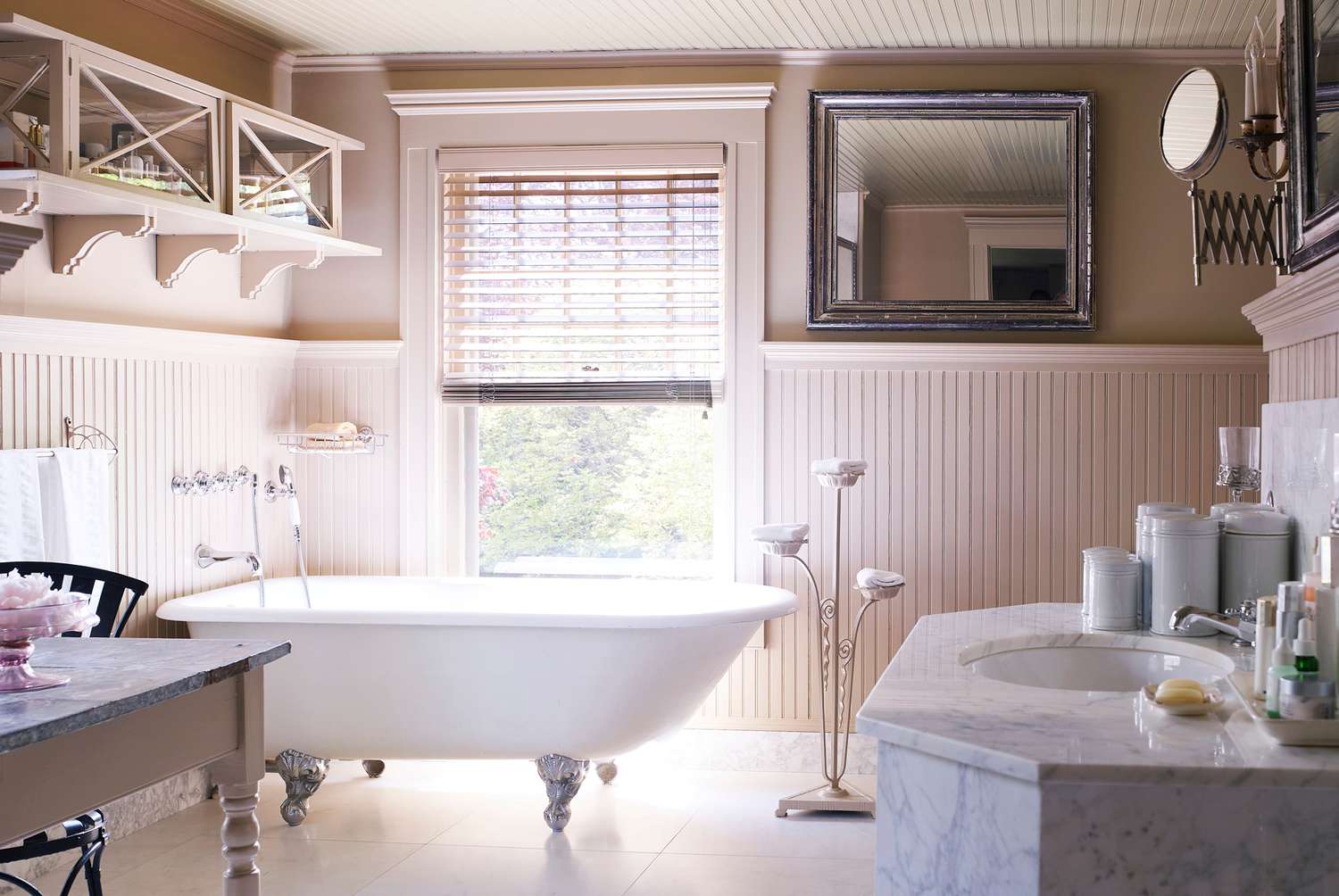 master bathroom with marble vanity and clawfoot tub