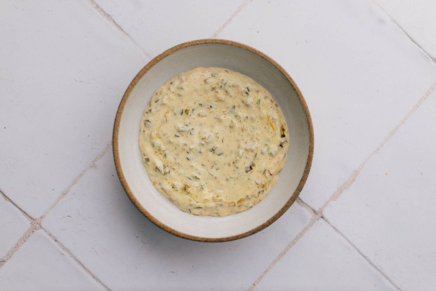 Mayonnaise, mustard, and relish mixed in a bowl
