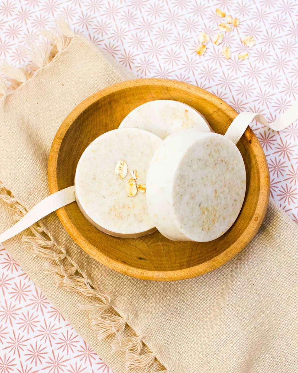 three bars of oatmeal soap in a wooden bowl