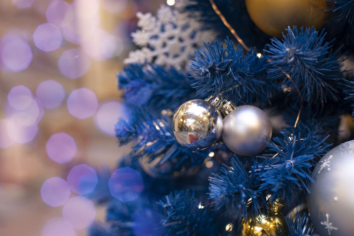 Closeup of decorated Christmas tree branches with ornaments