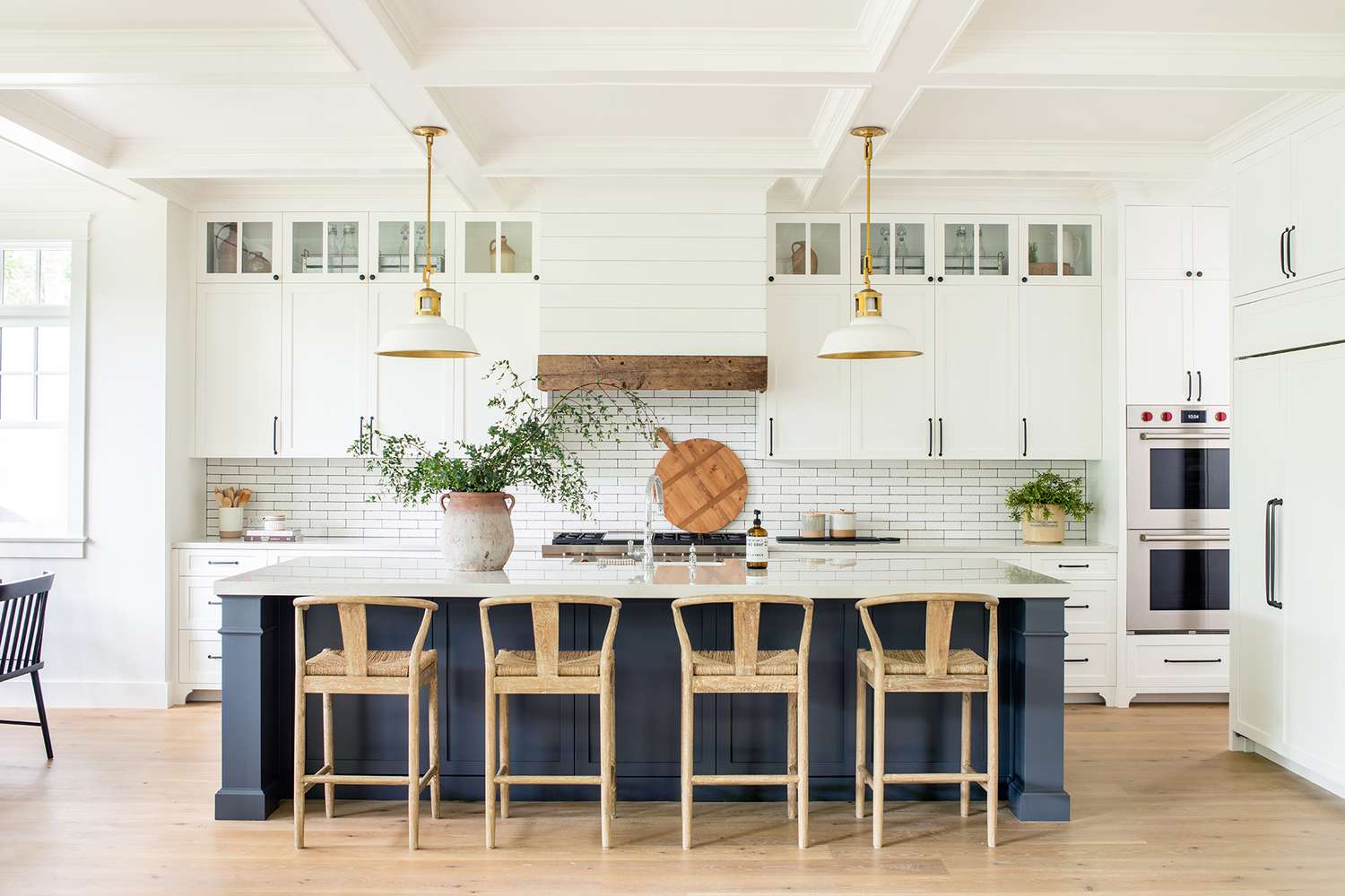 expansive white kitchen with wooden and navy accents