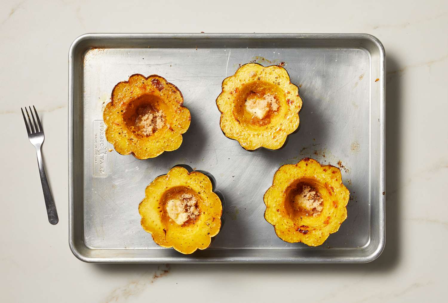 overhead view of cooked acorn squash on pan