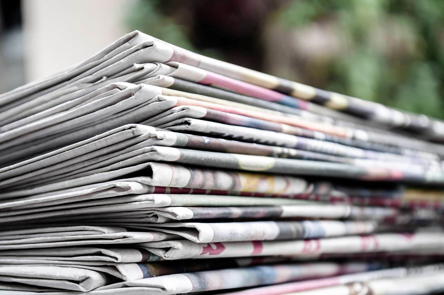 Stack of folded newspapers on a surface