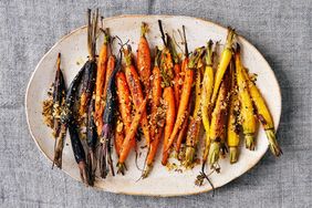 A dish of roasted carrots sprinkled with dukkah seasoning