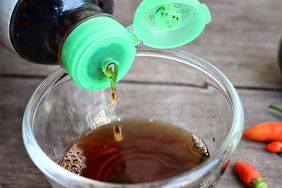 bottle of fish sauce being poured into a small bowl