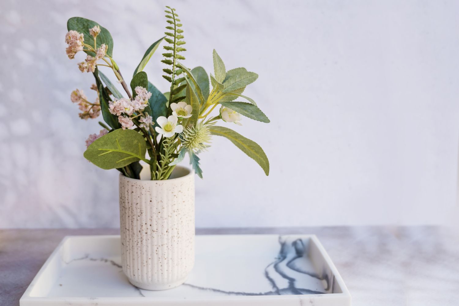 ceramic vase with green artificial plants
