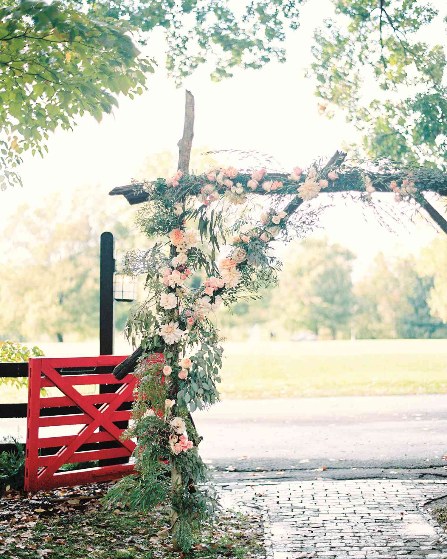 Unkempt Willow Branch Wedding Arch with Pink and Orange Flowers