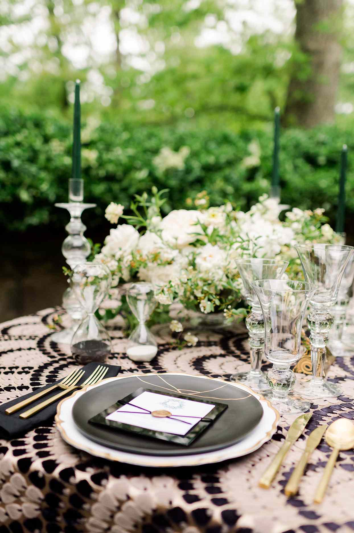 Scalloped, gold-rimmed chargers with black dinner plates