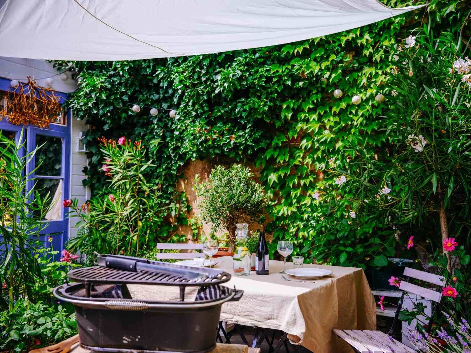 Barbeque cast iron grill and table ready for eating on terrace at home.