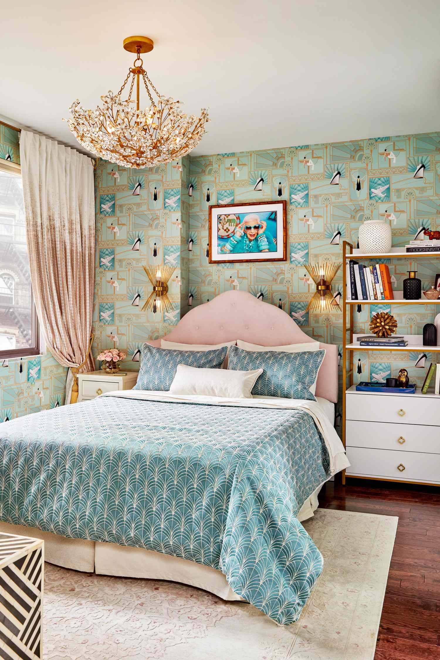 A stylish bedroom with a bed a unique patterned wallpaper wallmounted lighting and a decorative chandelier