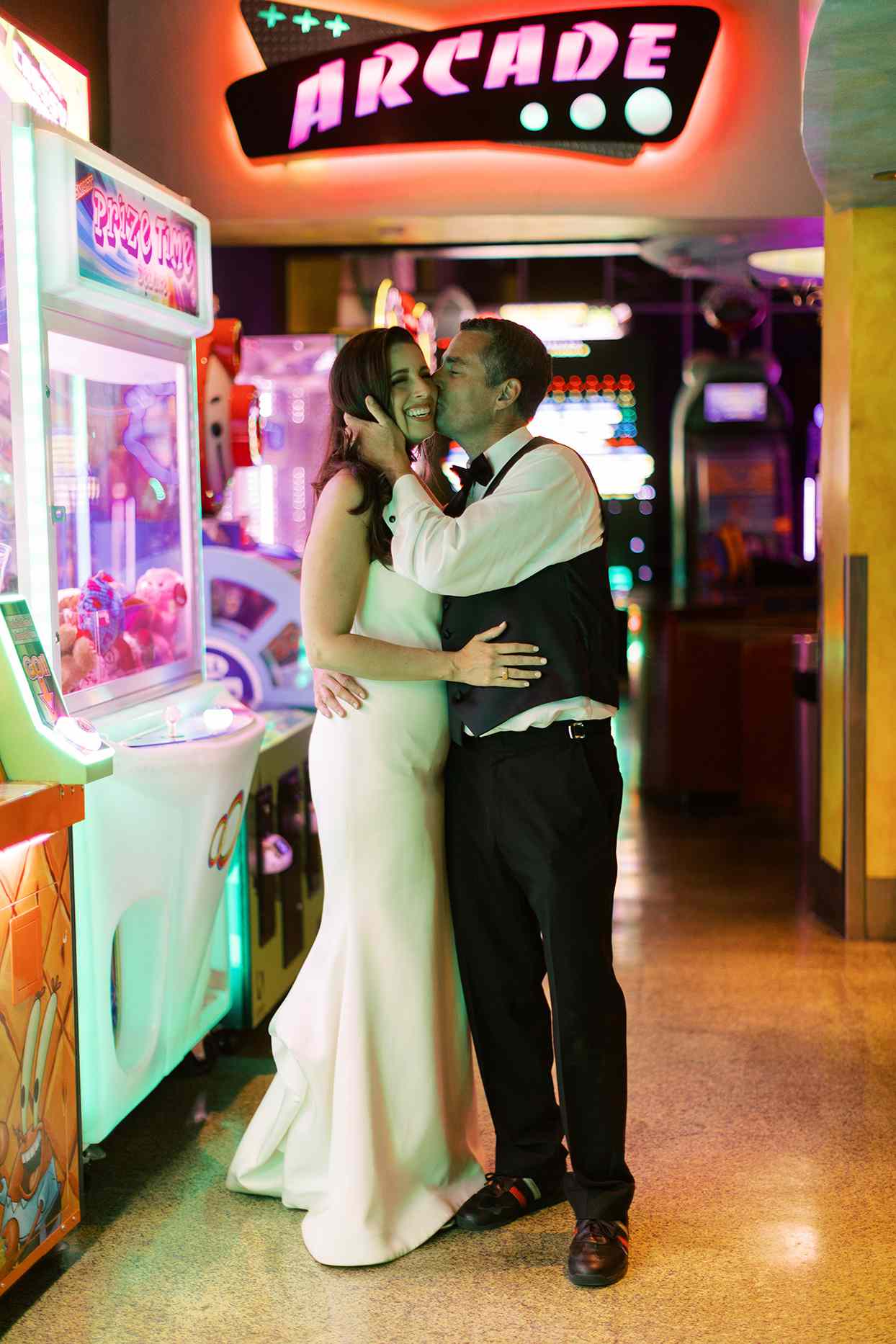 bride and groom at arcade after party under neon light