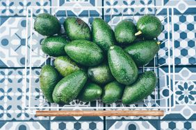 Full avocados in a wire basket