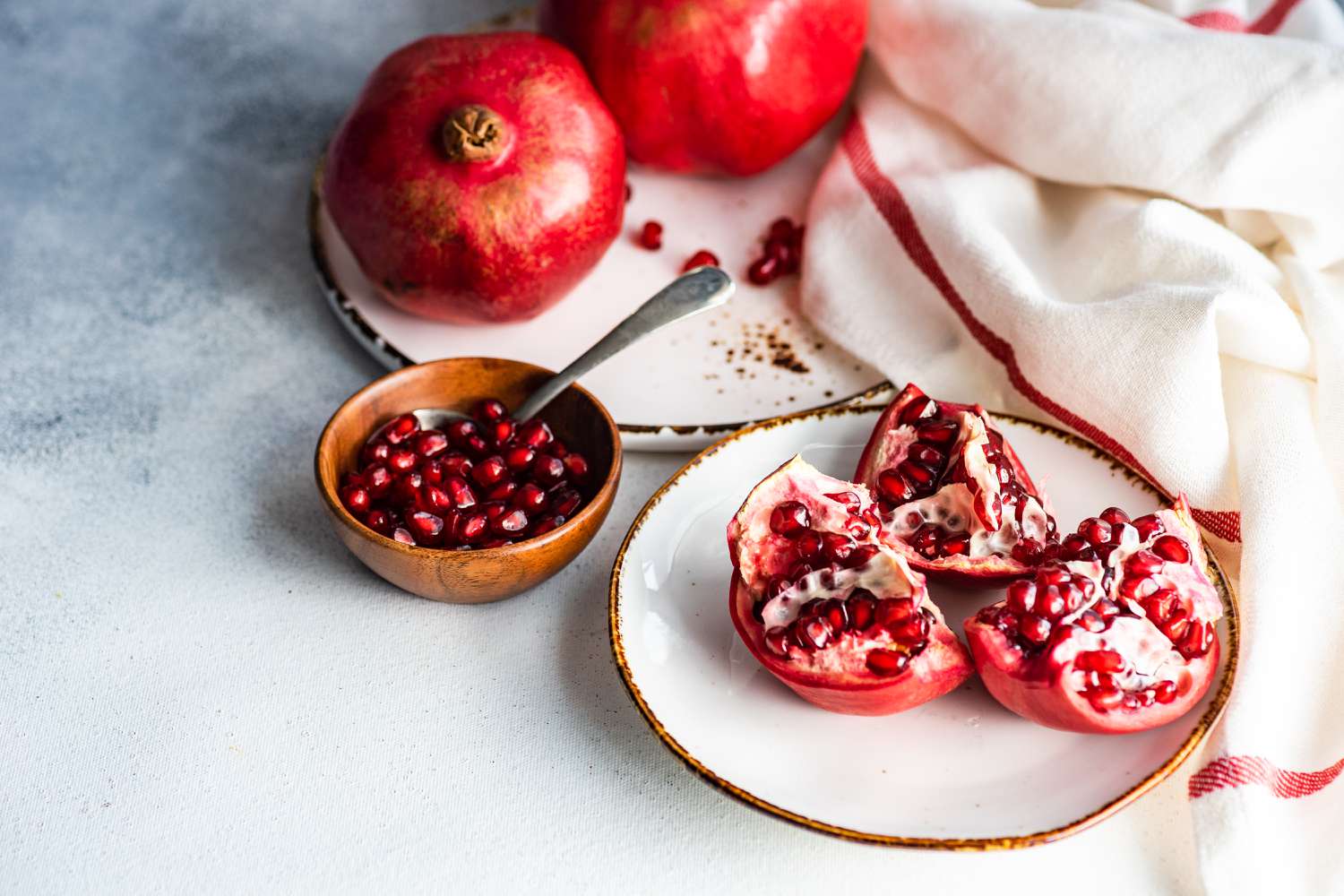 pomegranates and arils on plates
