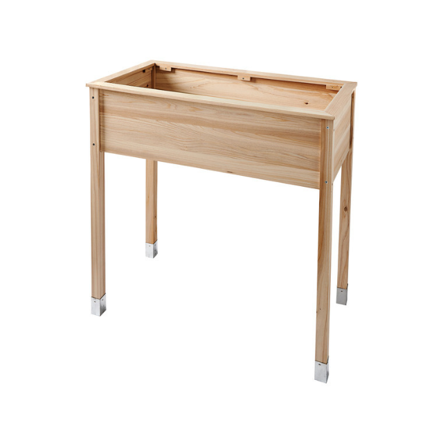 A wooden planter box with four legs and metallic foot caps
