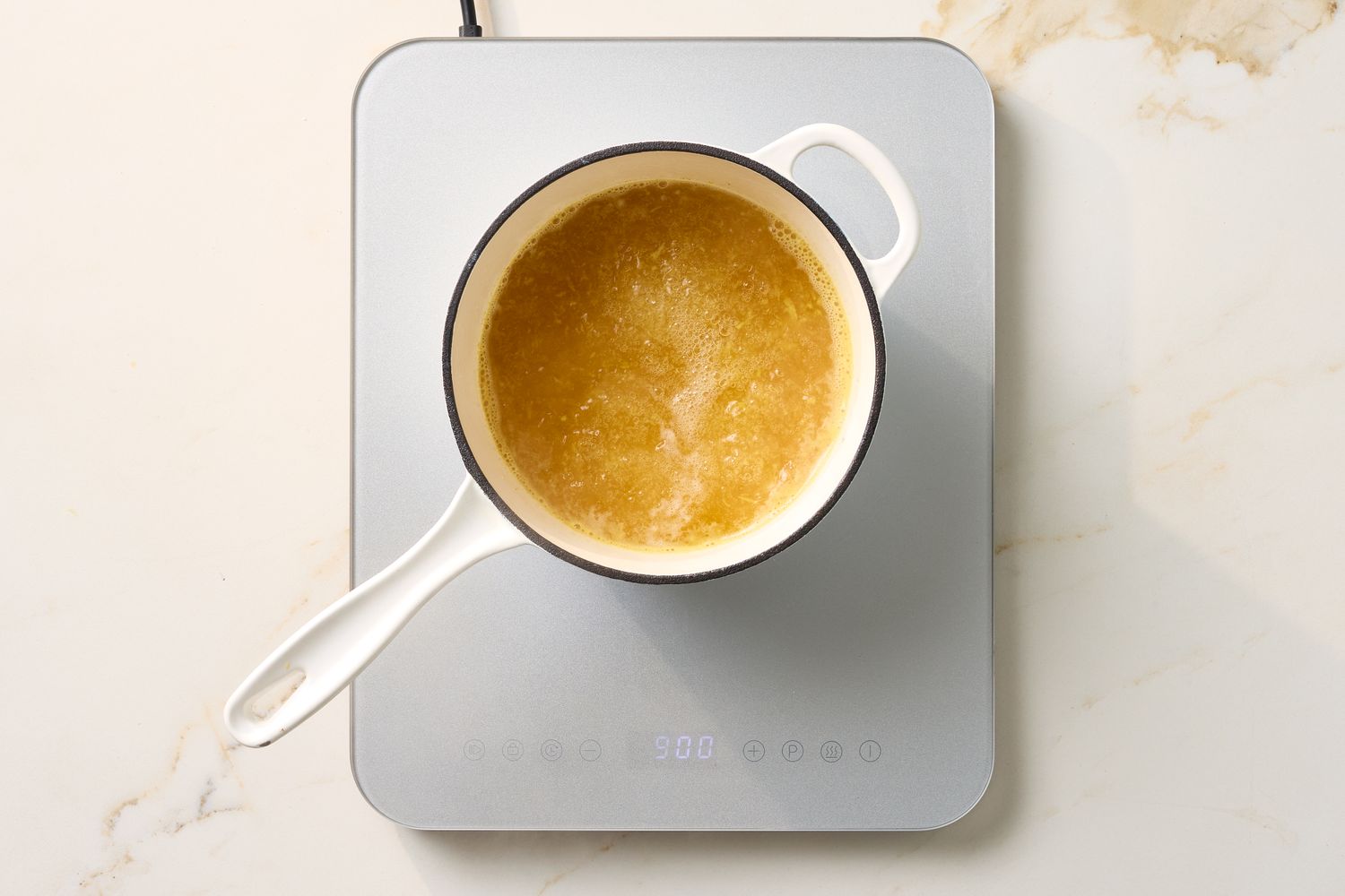 A pot of rice cooking on an induction cooktop