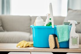 Home cleaning supplies in a bucket. 