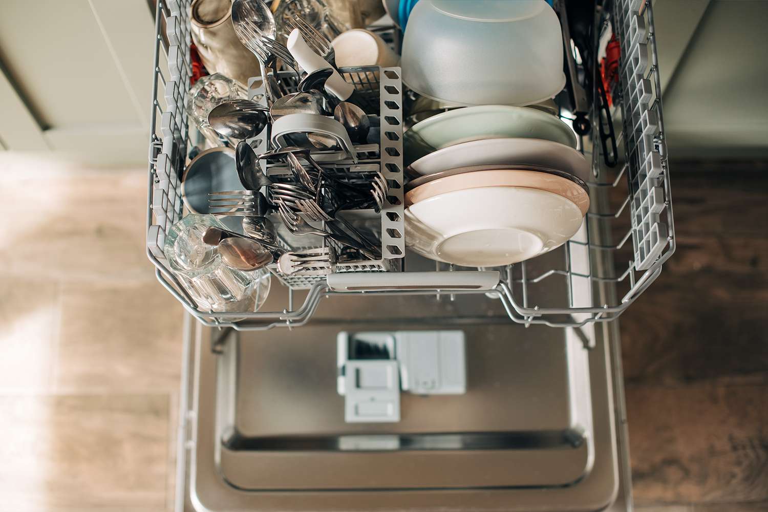 overhead view of open dishwasher full of dishes