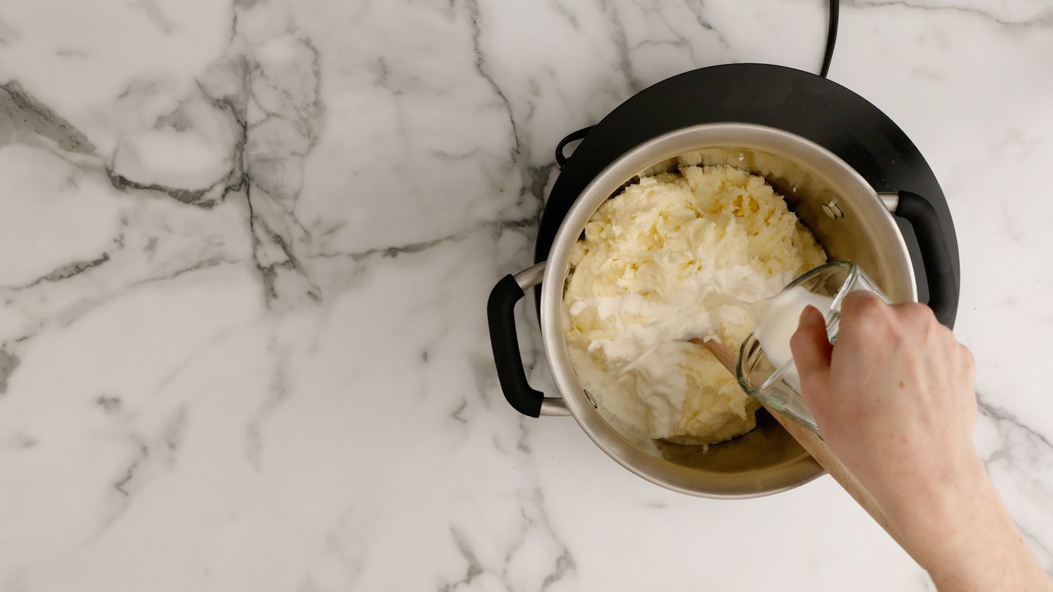 Adding cream to Big Martha's mashed potatoes