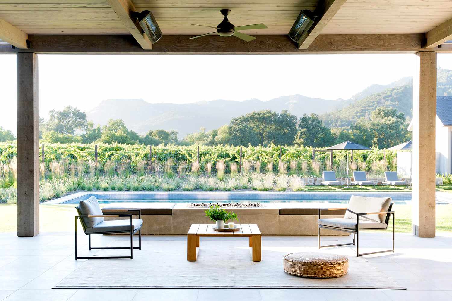 Backyard with pool, chairs, and wooden table