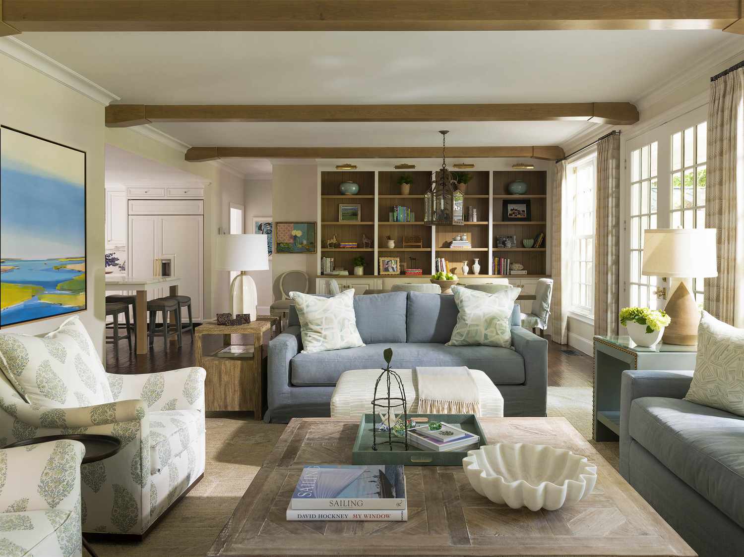Living room with blue couches and two reading chairs