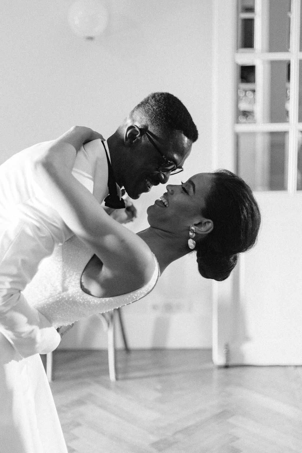 wedding couple dancing groom dipping bride while laughing