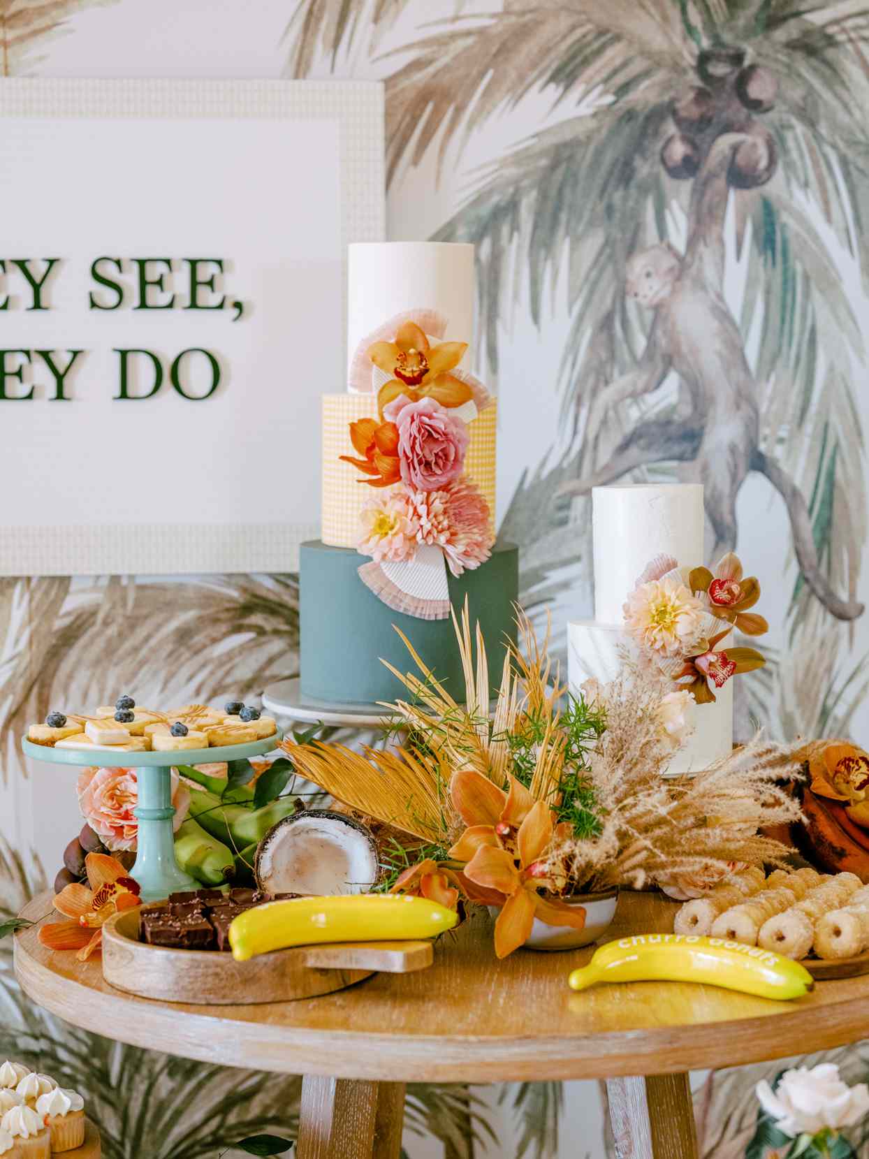 three-tiered wedding cake with yellow checkered middle tier and teal colored base tier