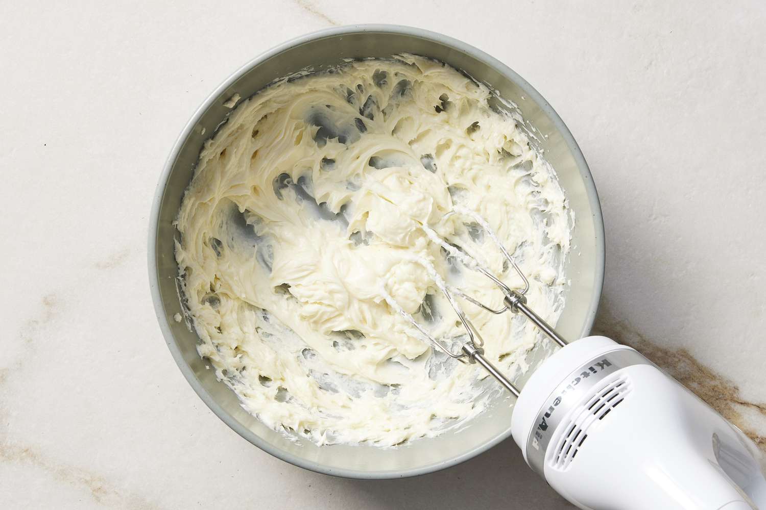 Frosting in bowl with hand mixer