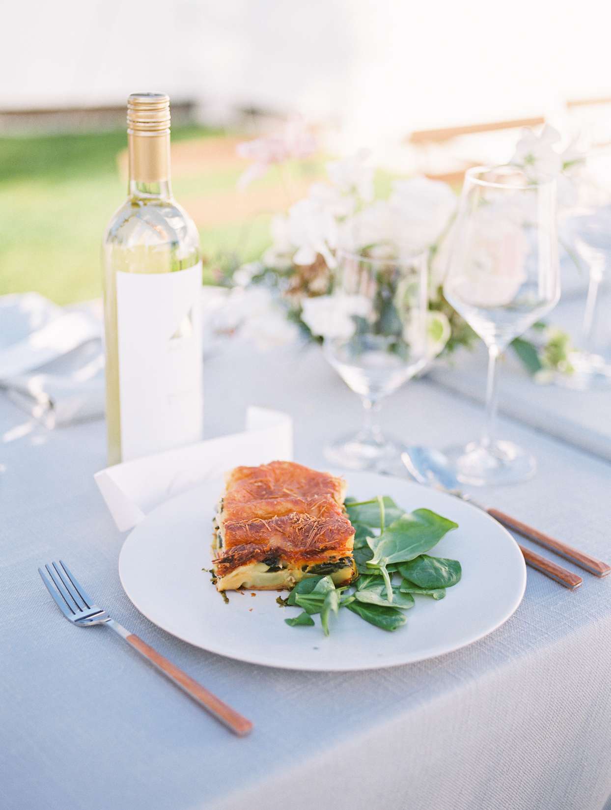 wedding food on white plate with pastel blue tablecloth
