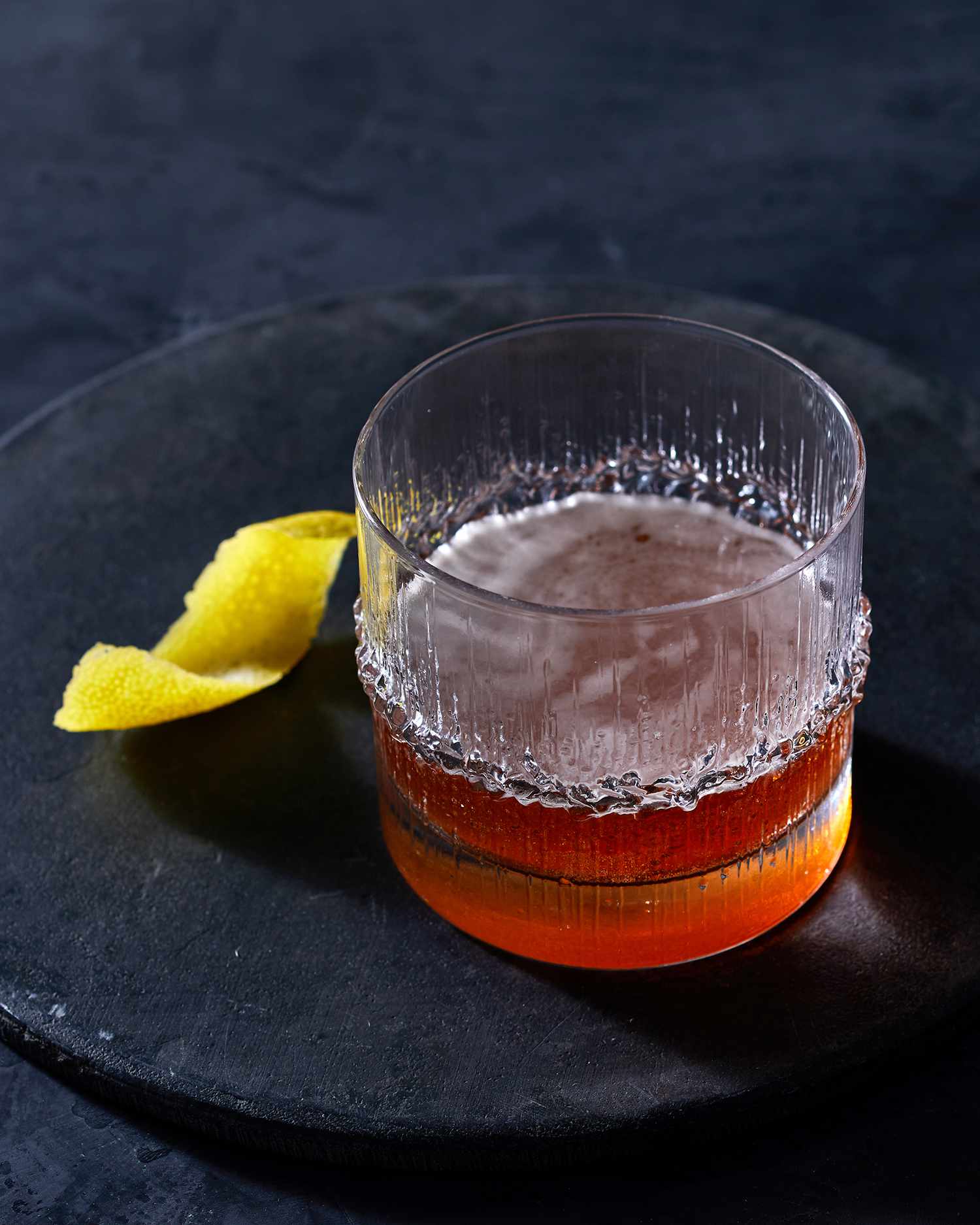 sazerac in rocks glass on black plate
