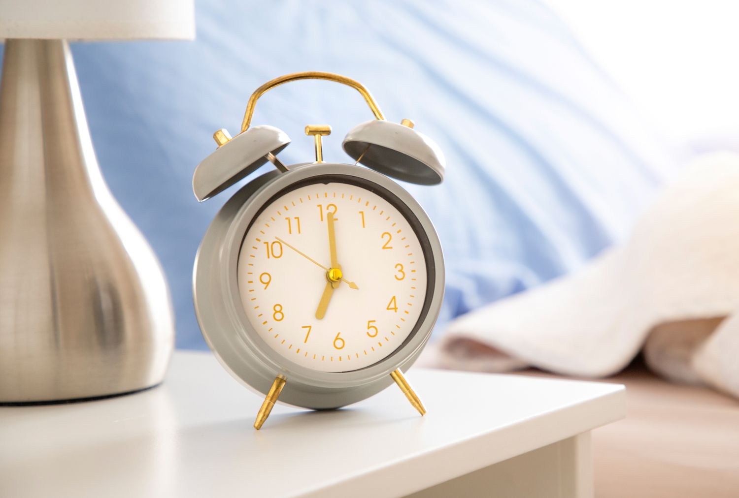 An alarm clock displayed on a bedside table