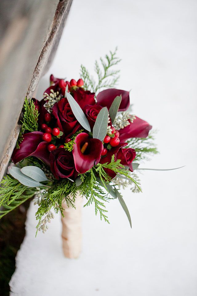 bouquet with red calla lilies berries and roses