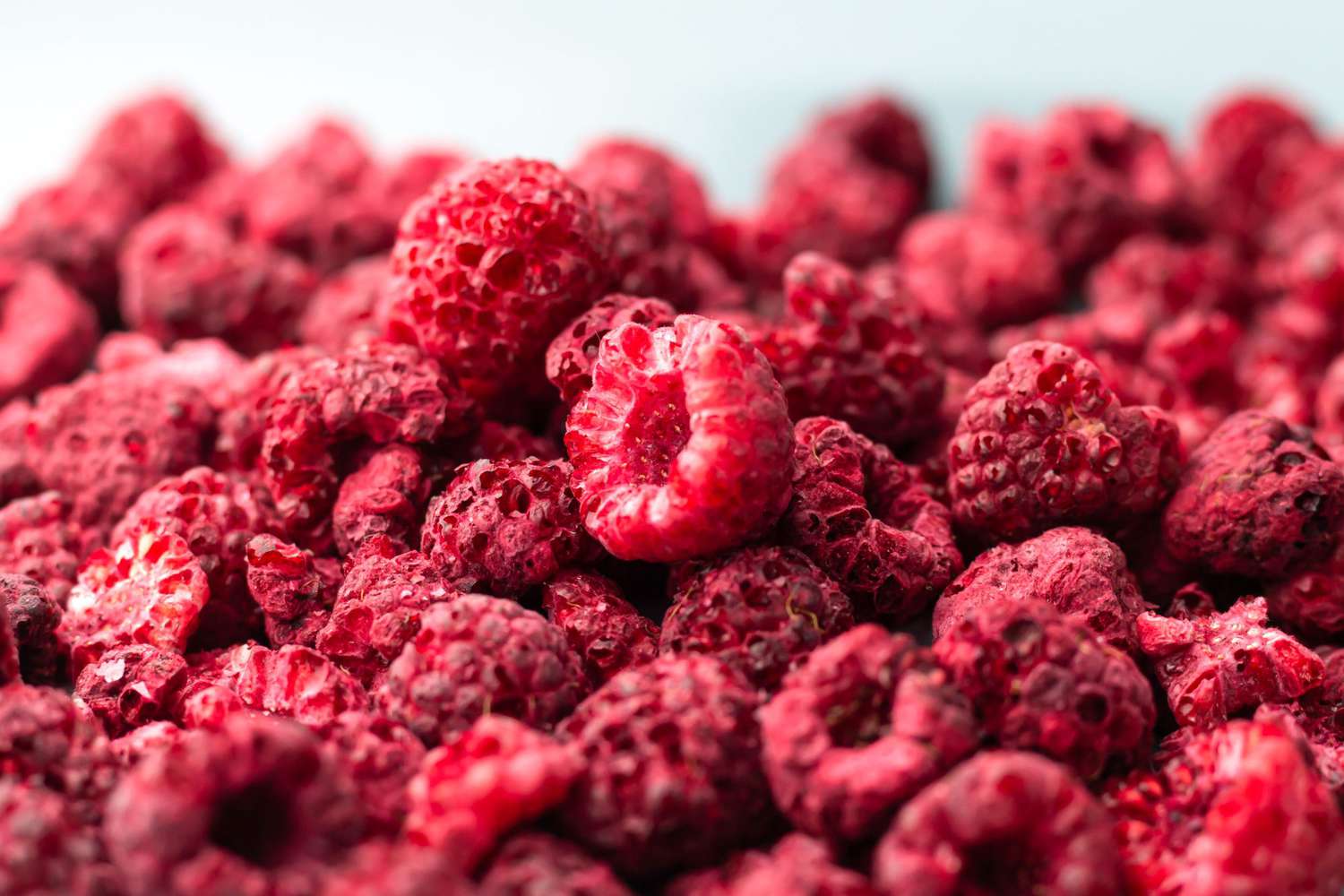 Heap of freeze dried raspberries close-up.